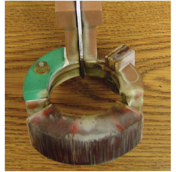 Fluxtrol - Virtual Prototyping of Induction Heat Treating Figure 1 An image of the original production coil with one piece of Fluxtrol A replacing a section of laminations.